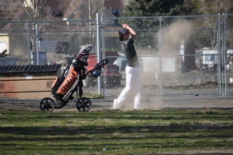 Hunter Ogle (11) chips out of the sand during a match at Lakeview Golf & Country Club.