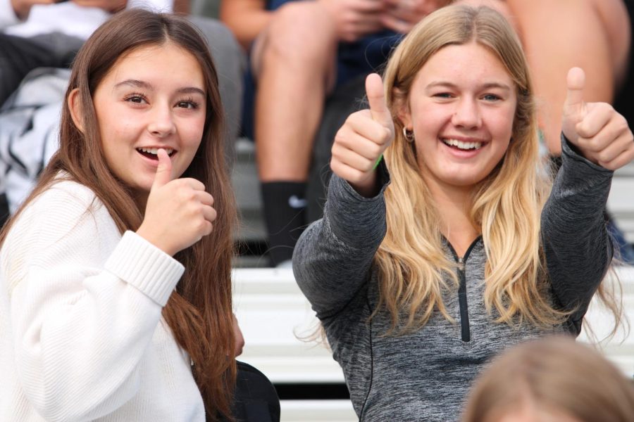 Chloe Ho (10) and Sienna Addink (10) give their approval during the fall sports assembly at Kiwanis Field on September 16, 2022.