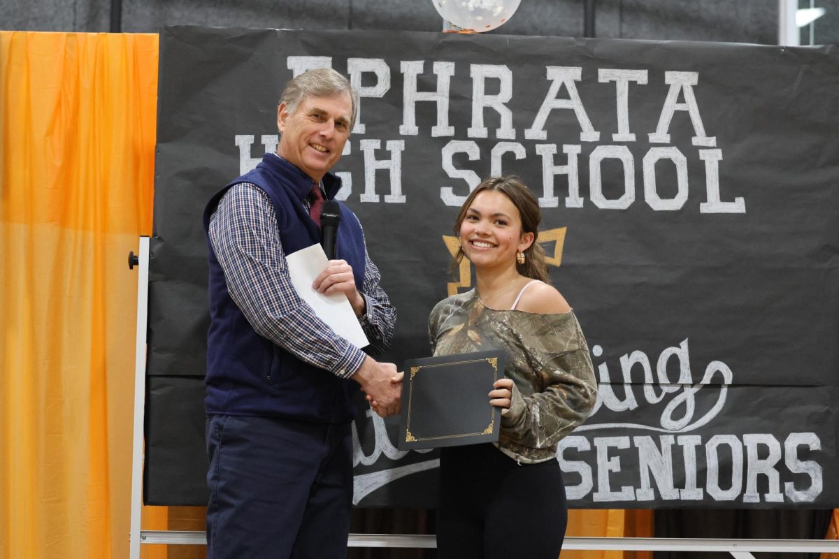 Joe Wolf congratulates Piper Francisco on receiving the Senior Award from the science department.  This was Wolfs final senior awards as a staff member at Ephrata High School.  He will retire following the conclusion of the 2023-2024 school year in June.